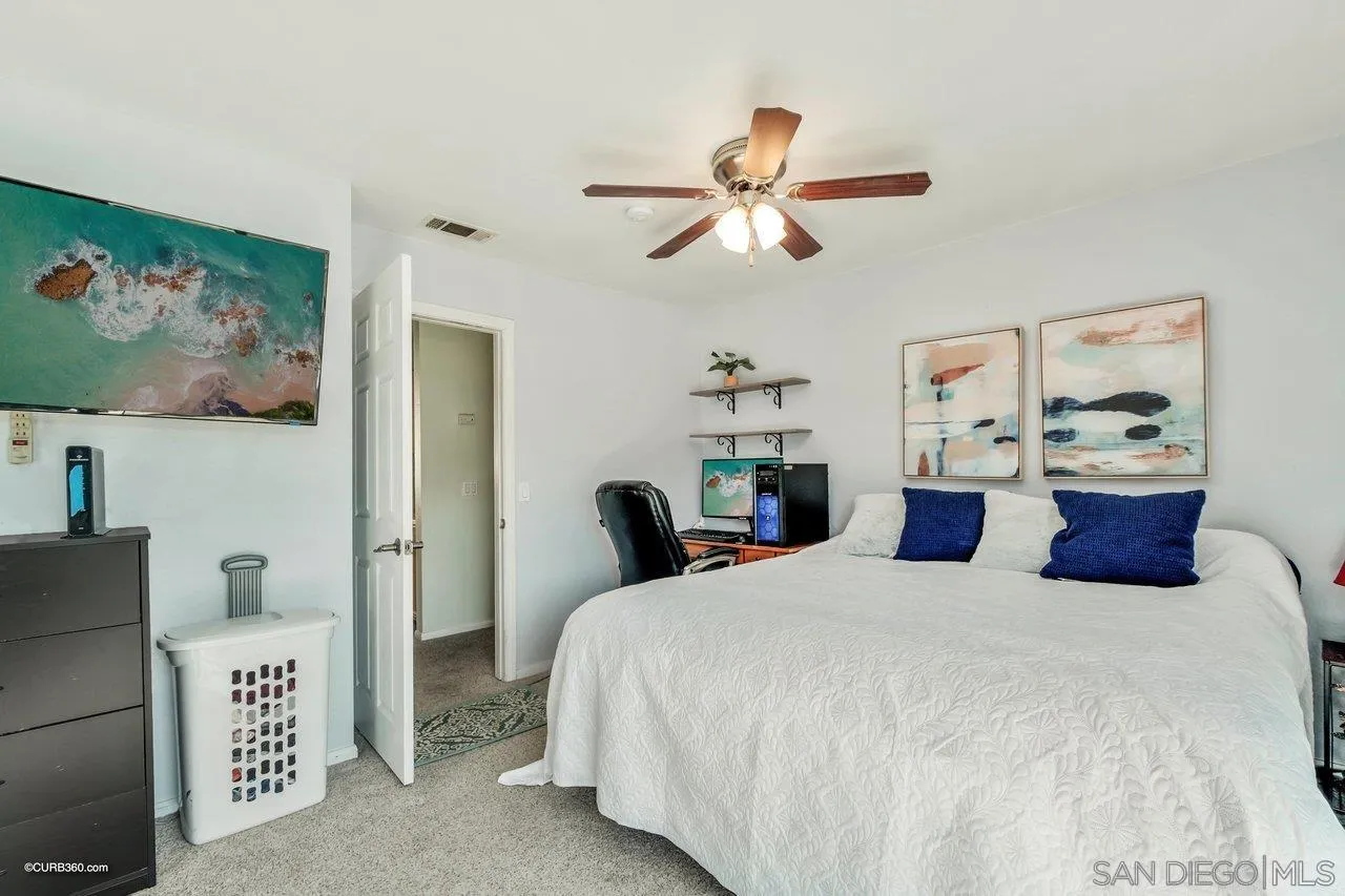 2648 Alpine Boulevard, Unit B Alpine, CA 91901 - Photo 18 of 25 a bedroom with a bed and a chandelier