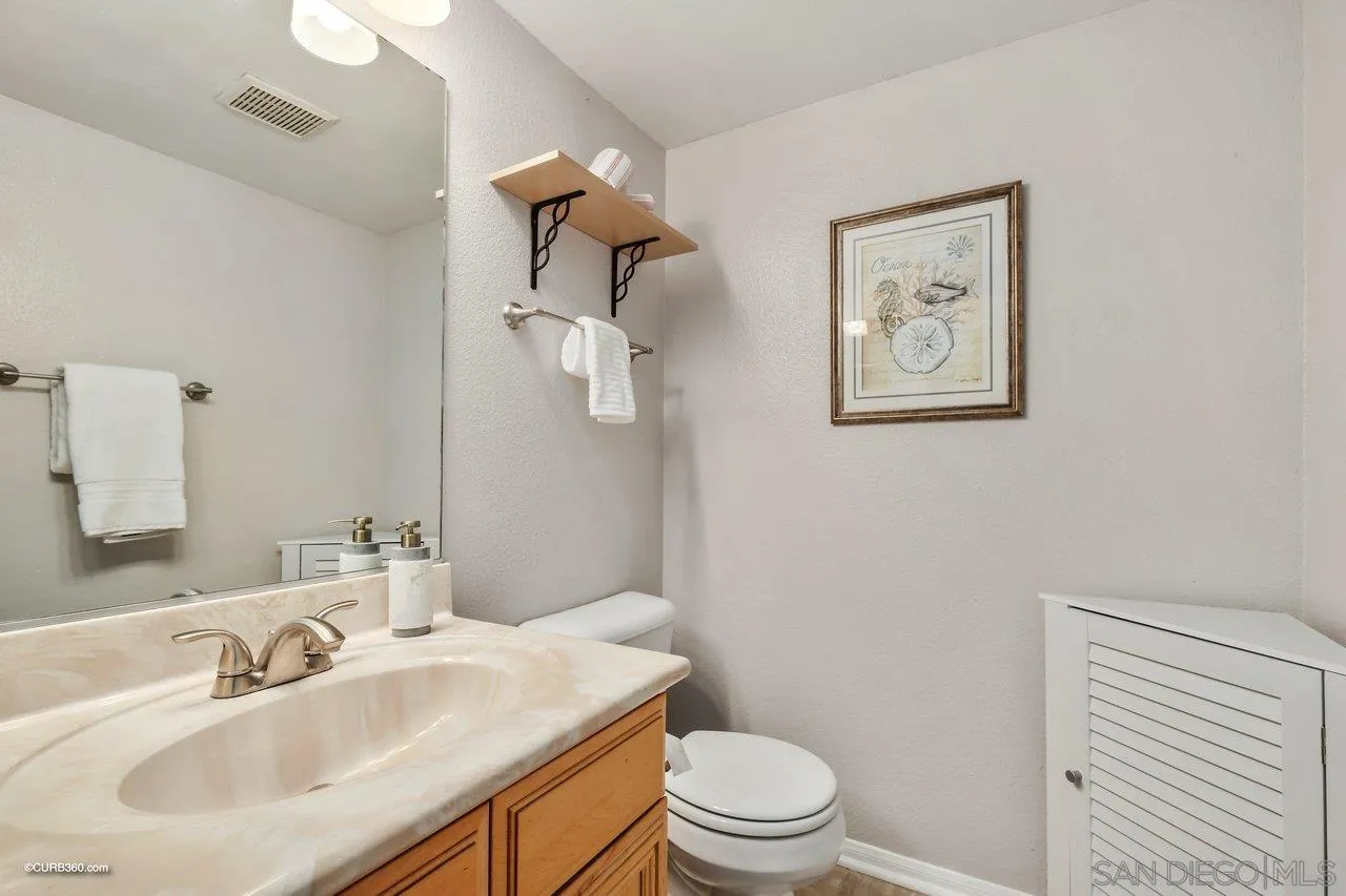 2648 Alpine Boulevard, Unit B Alpine, CA 91901 - Photo 6 of 25 a bathroom with a sink mirror vanity and toilet