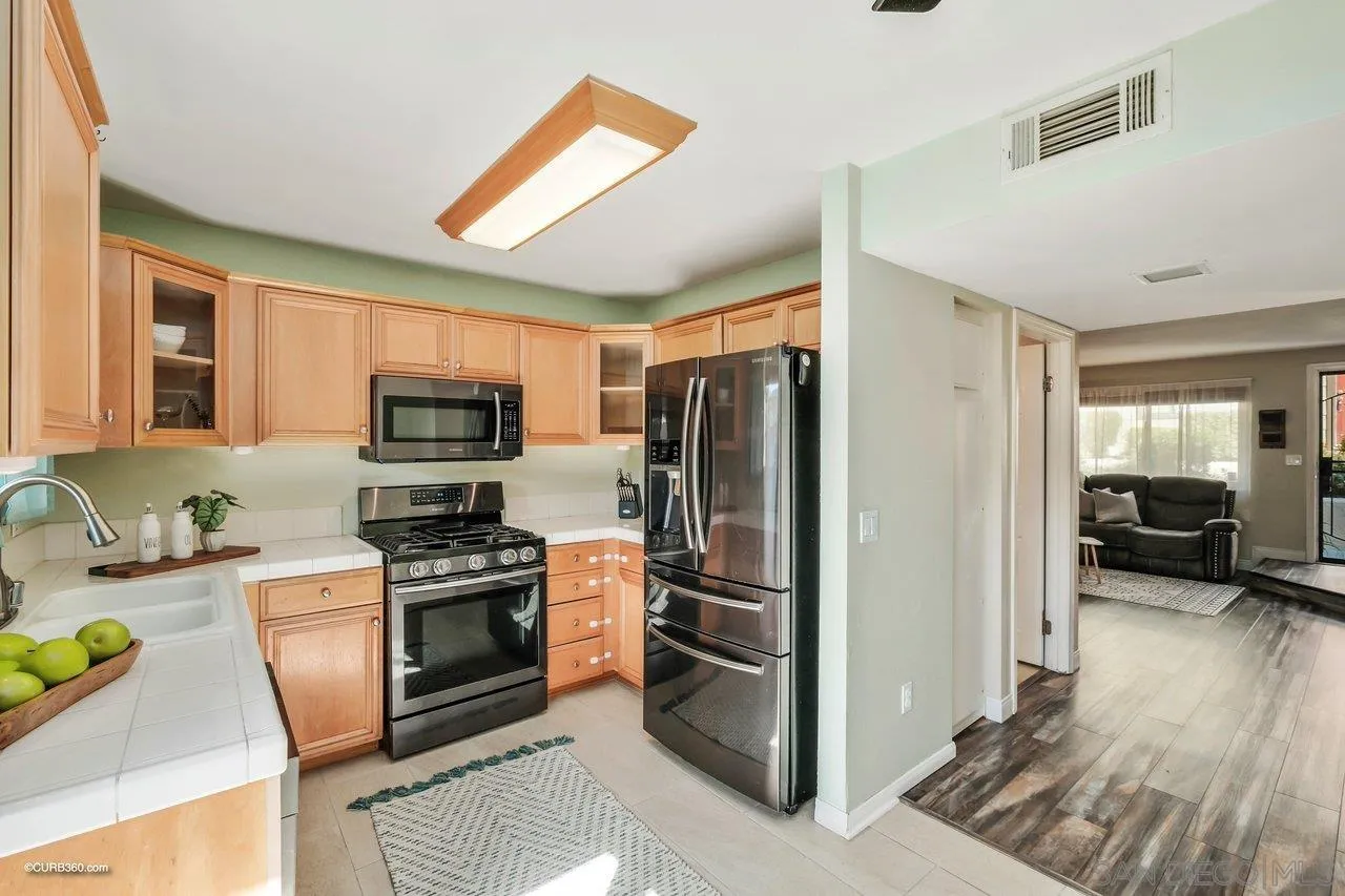 2648 Alpine Boulevard, Unit B Alpine, CA 91901 - Photo 8 of 25 a kitchen with stainless steel appliances granite countertop a refrigerator stove and sink