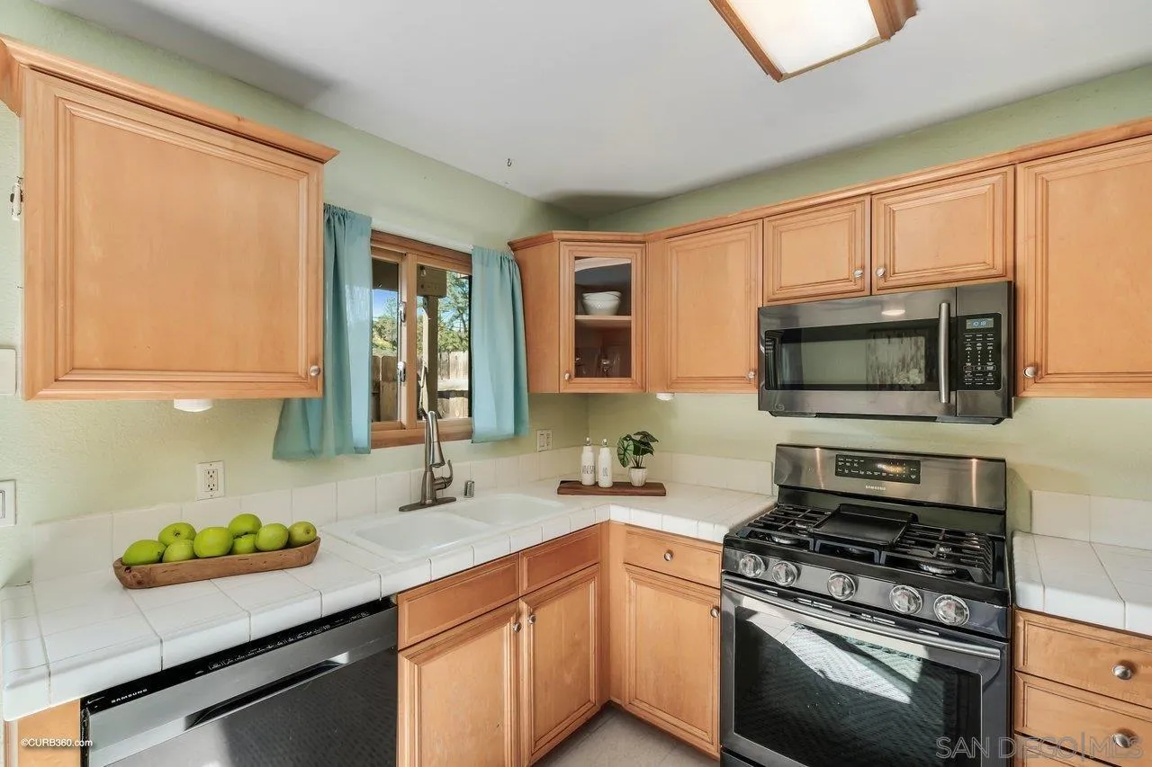 2648 Alpine Boulevard, Unit B Alpine, CA 91901 - Photo 9 of 25 a kitchen with stainless steel appliances a stove a sink and a microwave