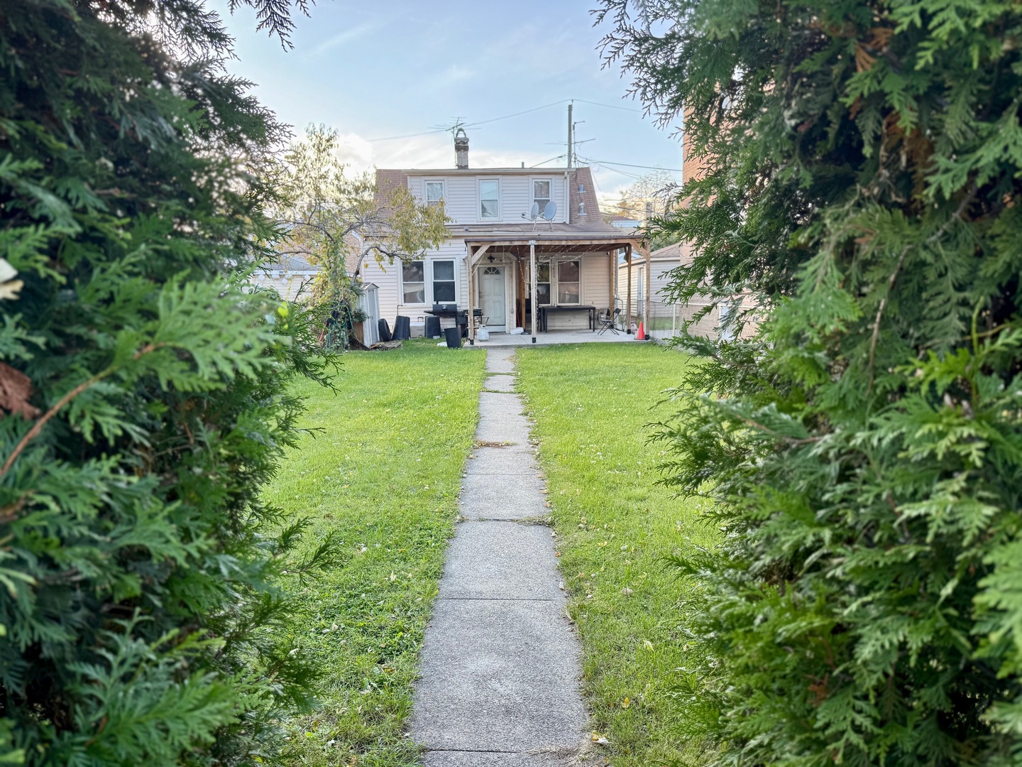 5424 South Kenneth Avenue Chicago, IL 60632 - Photo 1 of 2 a view of a brick house with a big yard plants and large trees