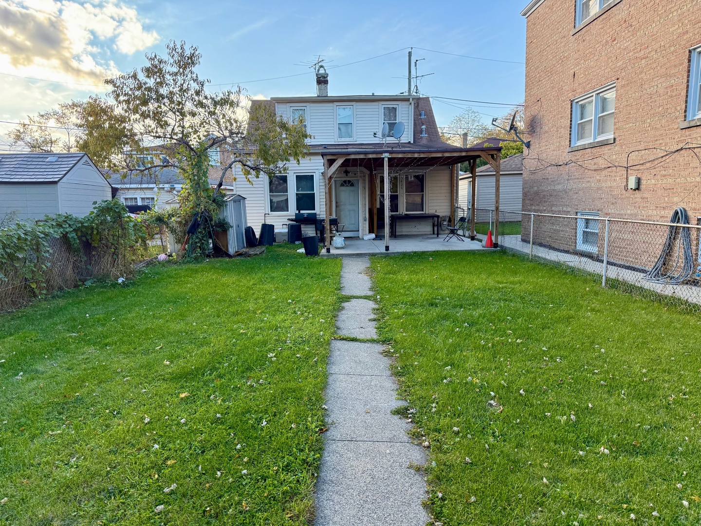 5424 South Kenneth Avenue Chicago, IL 60632 - Photo 2 of 2 a view of a patio with table and chairs potted plants and large tree