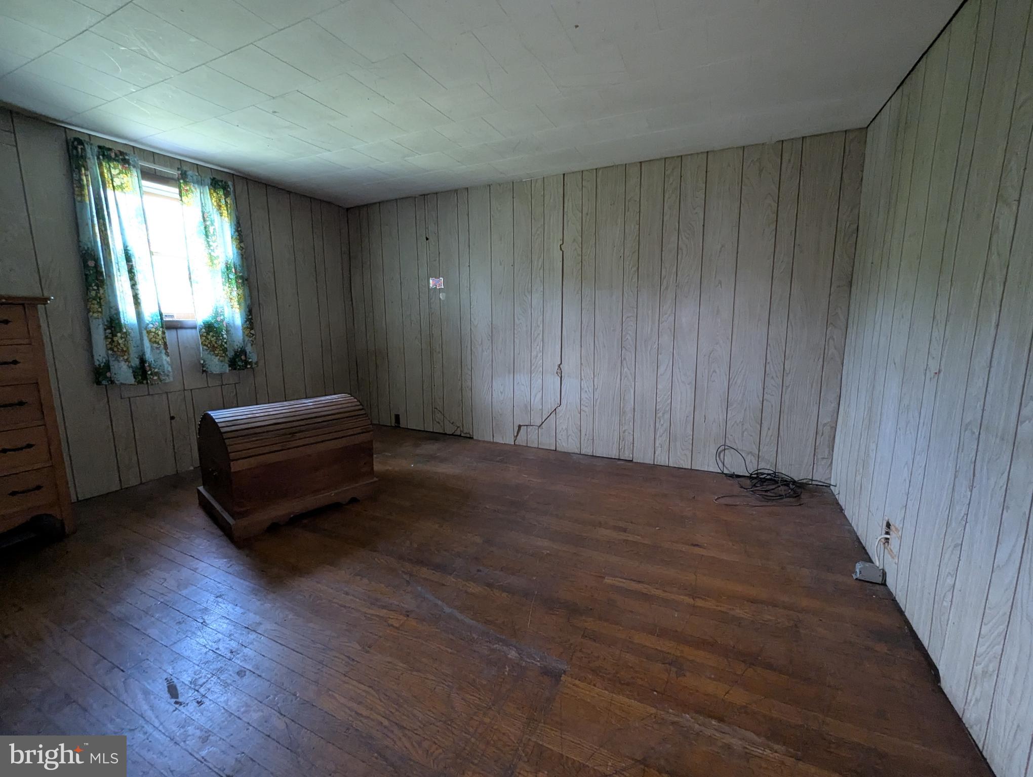 24001 Perry Hill Road Barton, MD 21521 - Photo 31 of 37 a view of a room with wooden floor and windows