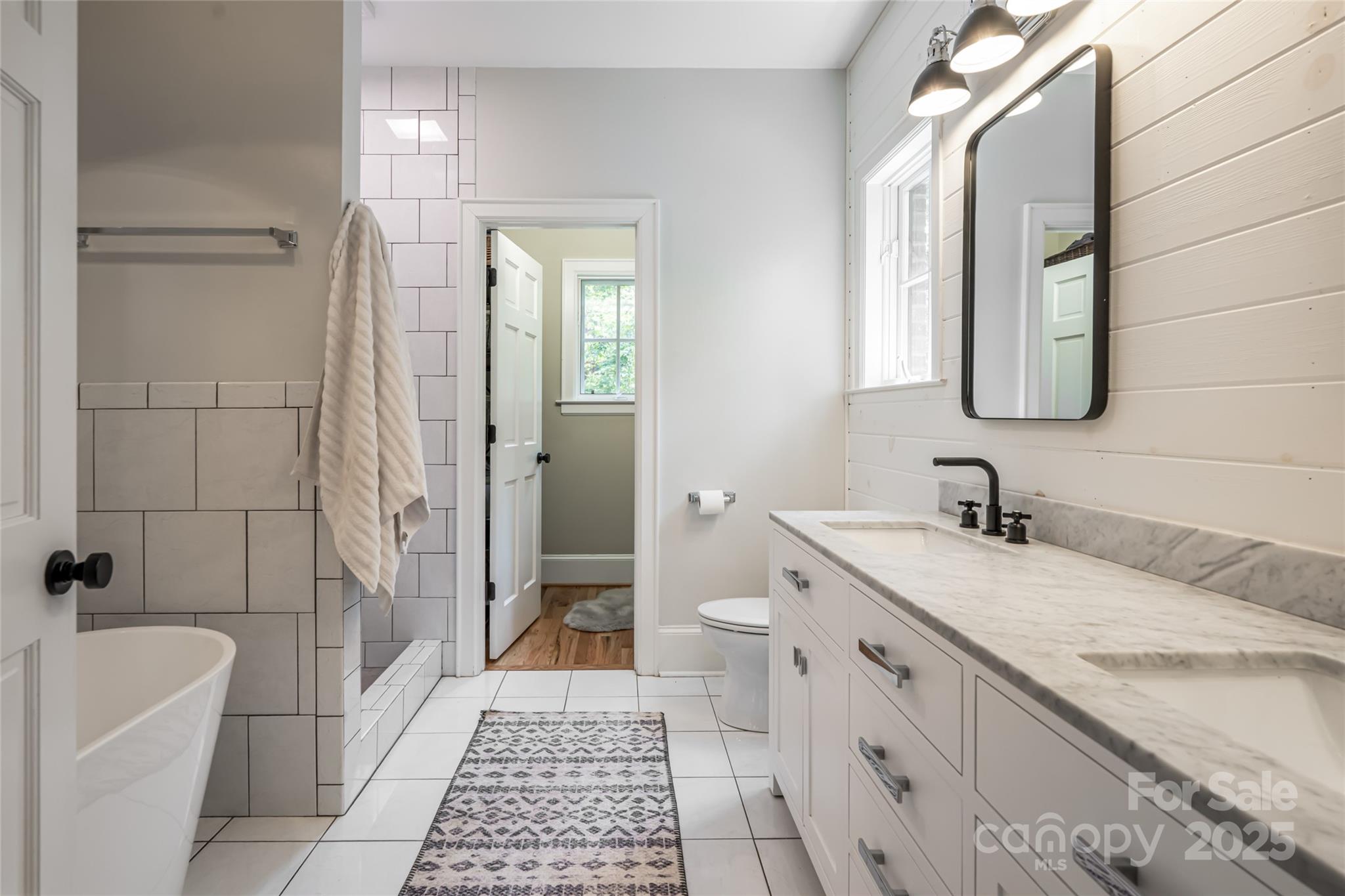3 Lone Pine Road Biltmore Forest, NC 28803 - Photo 17 of 47 a bathroom with a granite countertop sink a toilet a mirror and shower