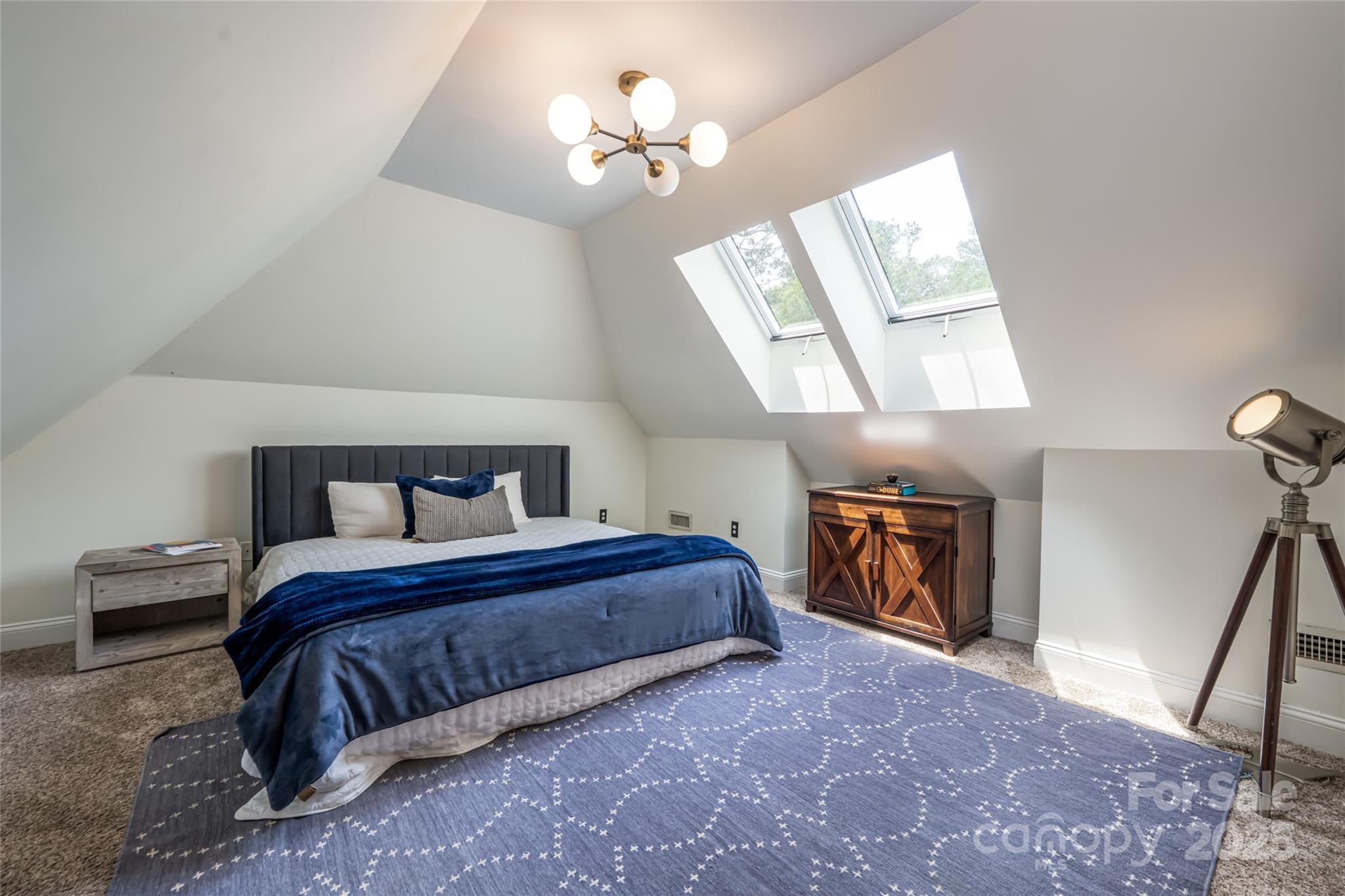 3 Lone Pine Road Biltmore Forest, NC 28803 - Photo 27 of 47 a bedroom with a bed and a chandelier