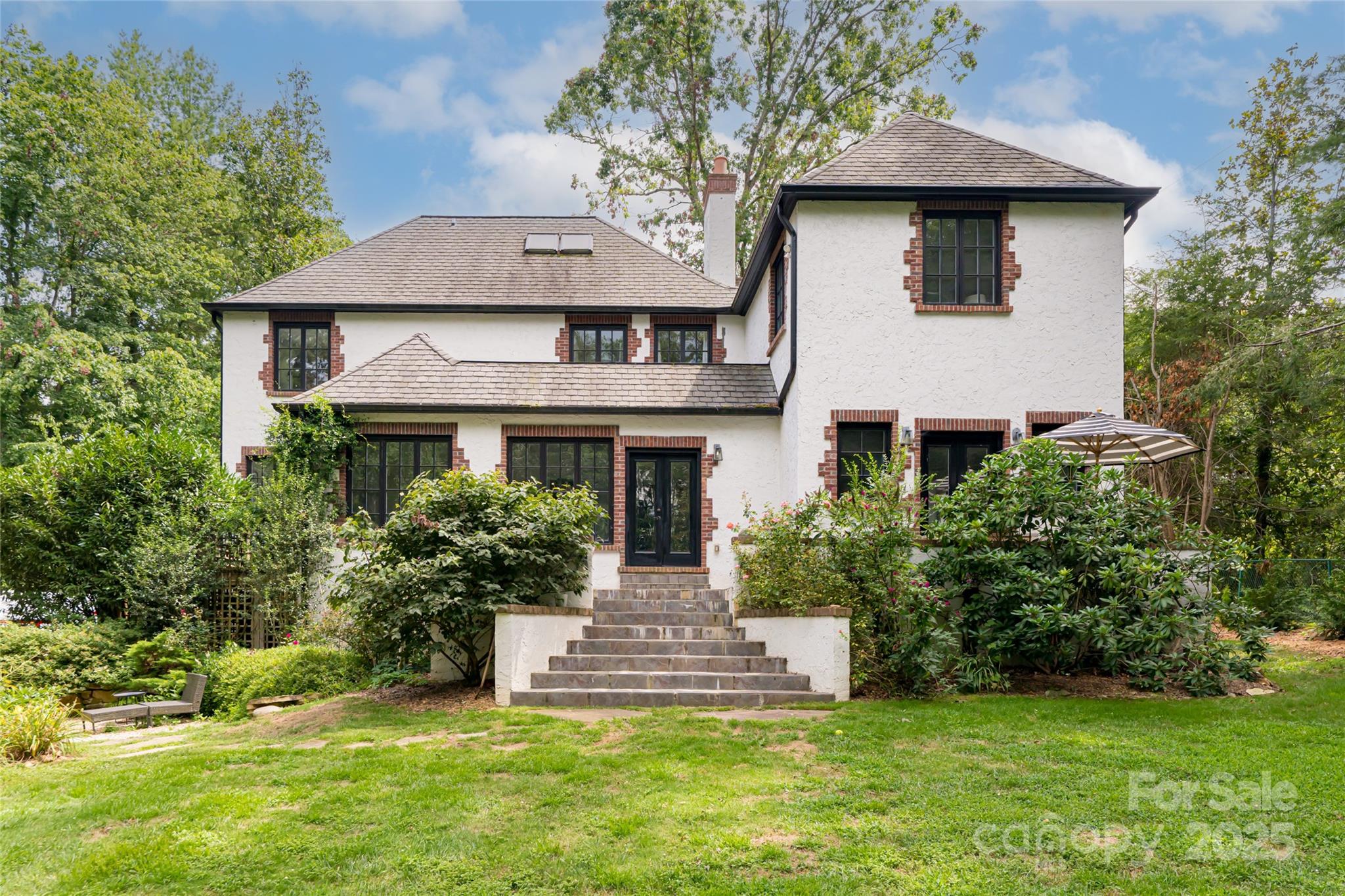 3 Lone Pine Road Biltmore Forest, NC 28803 - Photo 31 of 47 a front view of a house with a yard and garage