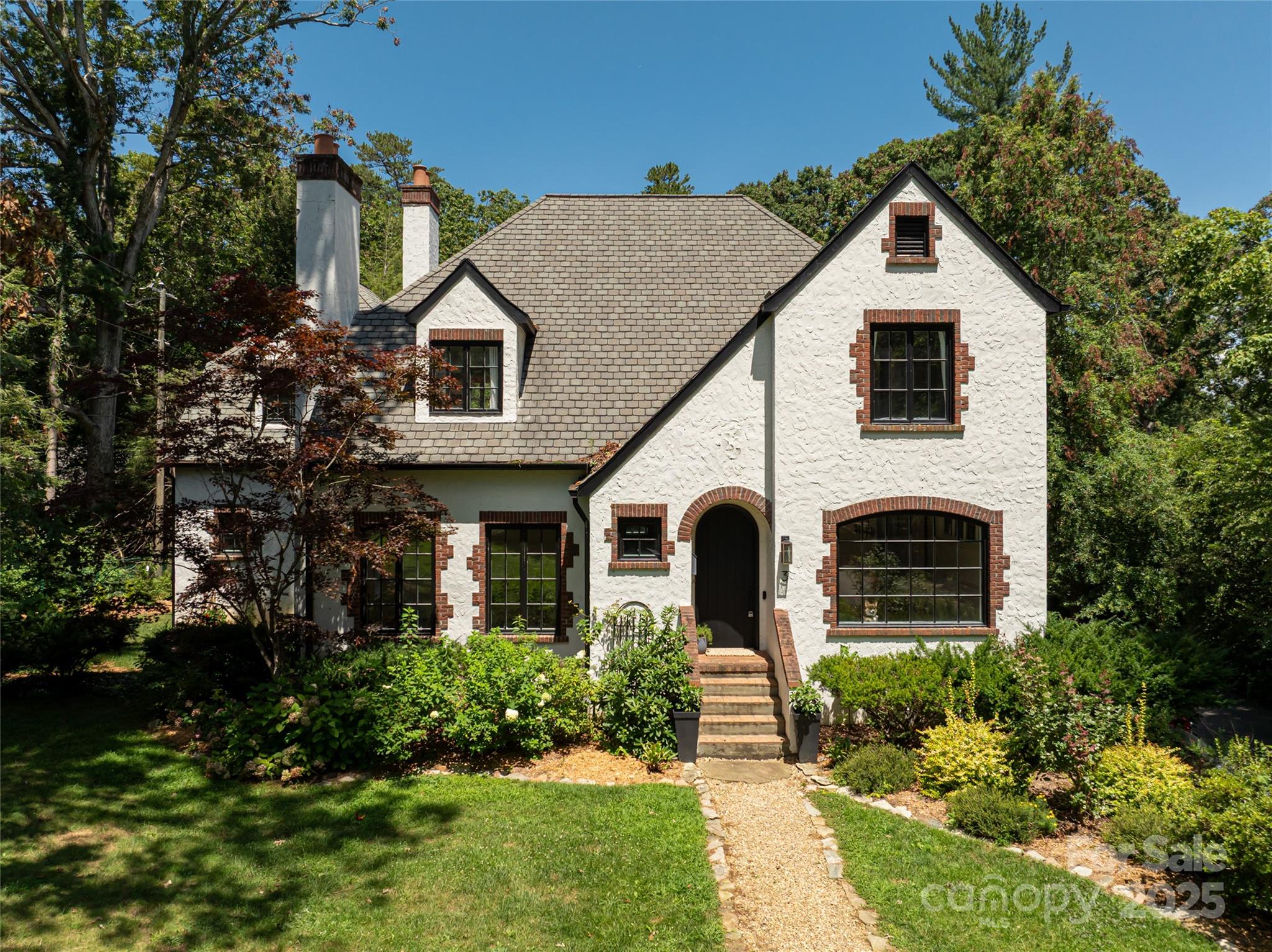 3 Lone Pine Road Biltmore Forest, NC 28803 - Photo 47 of 47 a front view of a house with a yard and garage