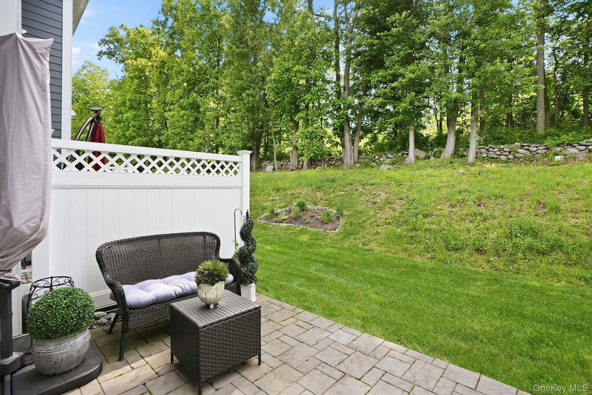 8 Muscoot River Road Granite Springs, NY 10527 - Photo 34 of 40 Outdoor grass area with private paver patio and white lattice fencing