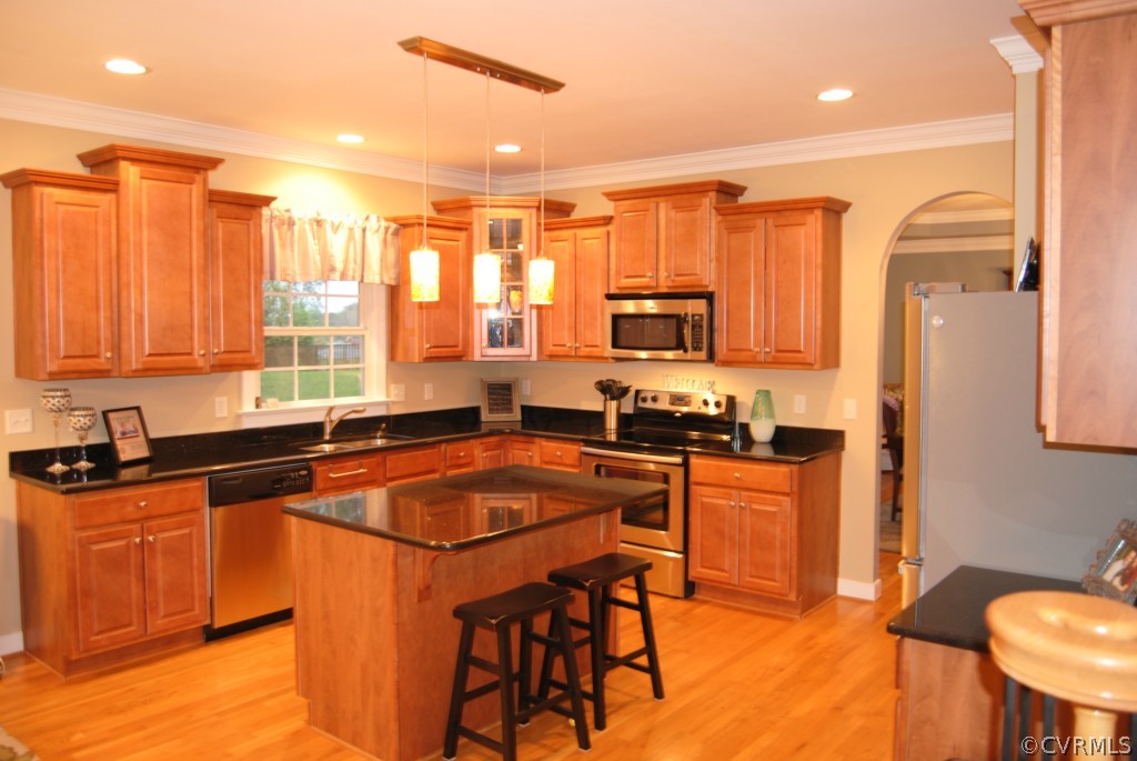 472 Three Chopt Road Manakin-Sabot, VA 23103 - Photo 5 of 23 a kitchen with stainless steel appliances granite countertop a stove a sink a microwave a refrigerator and chairs