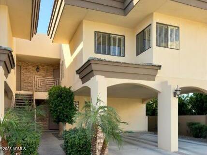 3235 East Camelback Road, Unit 104 Phoenix, AZ 85018 - Photo 1 of 17 a front view of a house with plants