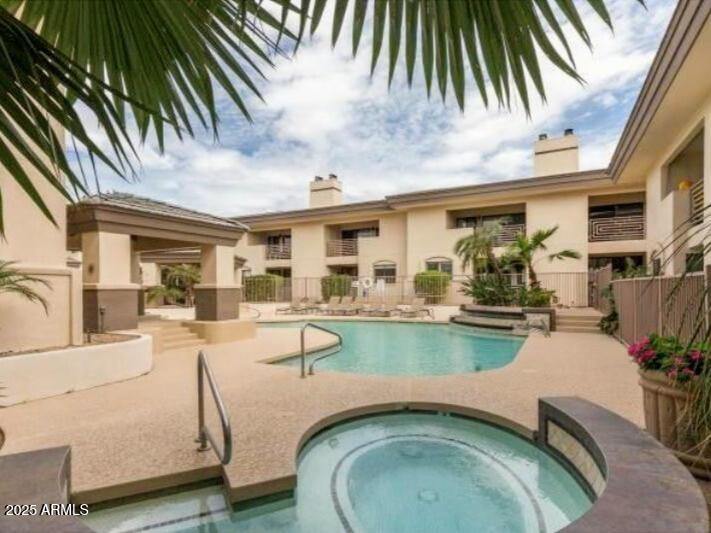 3235 East Camelback Road, Unit 104 Phoenix, AZ 85018 - Photo 16 of 17 a swimming pool with outdoor seating and yard