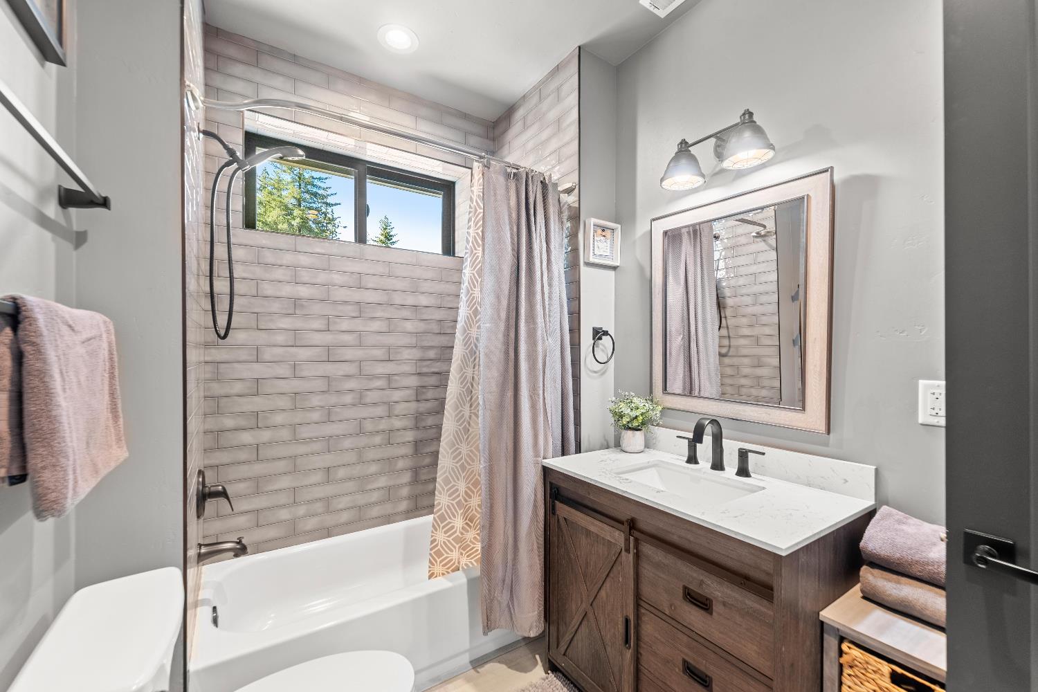29115 Secret Town Road Colfax, CA 95713 - Photo 37 of 82 a bathroom with a sink a toilet and shower