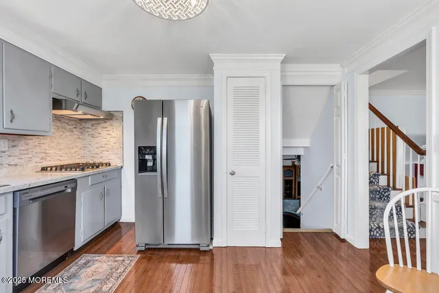 a kitchen with stainless steel appliances granite countertop a refrigerator and a stove top oven