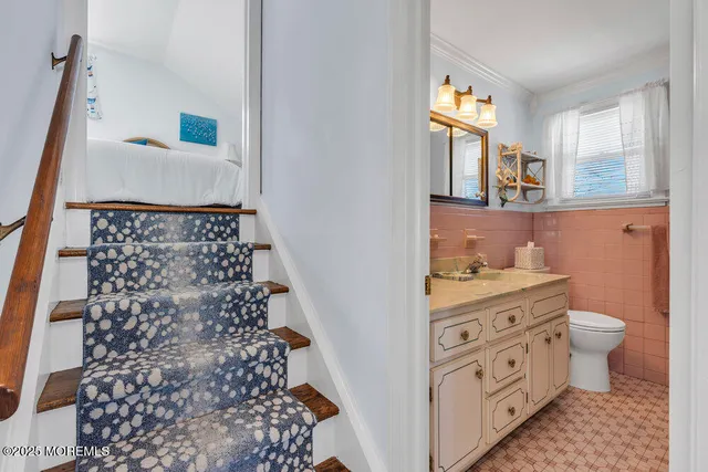 a bathroom with a granite countertop sink a toilet and a mirror