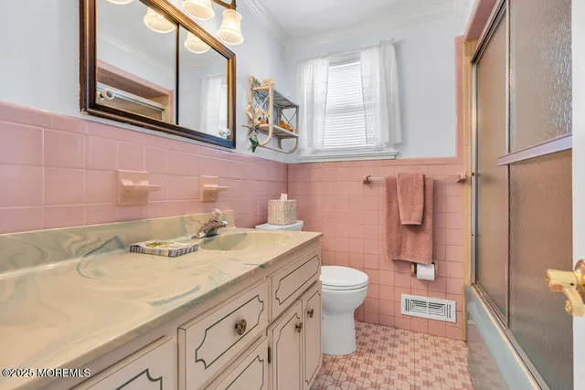 a bathroom with a granite countertop sink a toilet and a mirror
