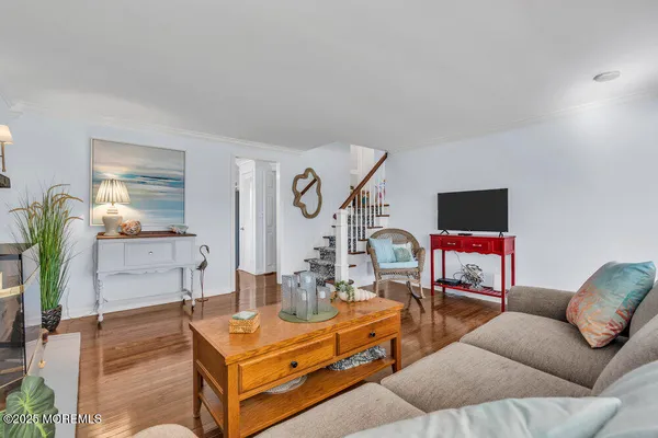 a living room with furniture kitchen view and a potted plant