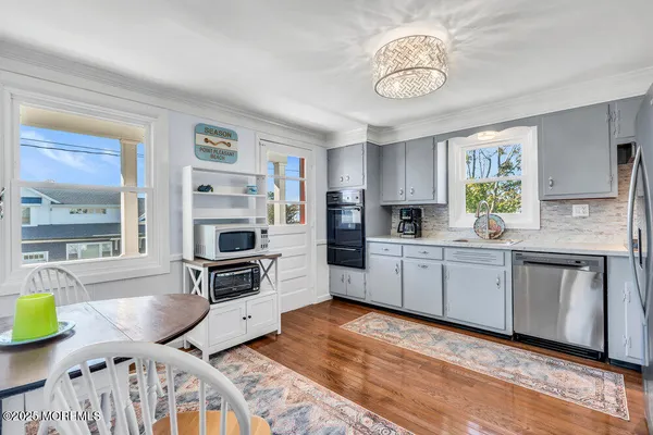 a kitchen with stainless steel appliances kitchen island granite countertop a stove a sink and a microwave