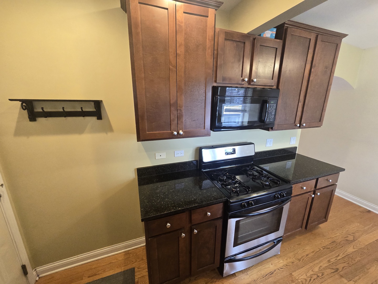 56 Forest Avenue, Unit 3N Riverside, IL 60546 - Photo 4 of 10 a kitchen with granite countertop cabinets and black appliances