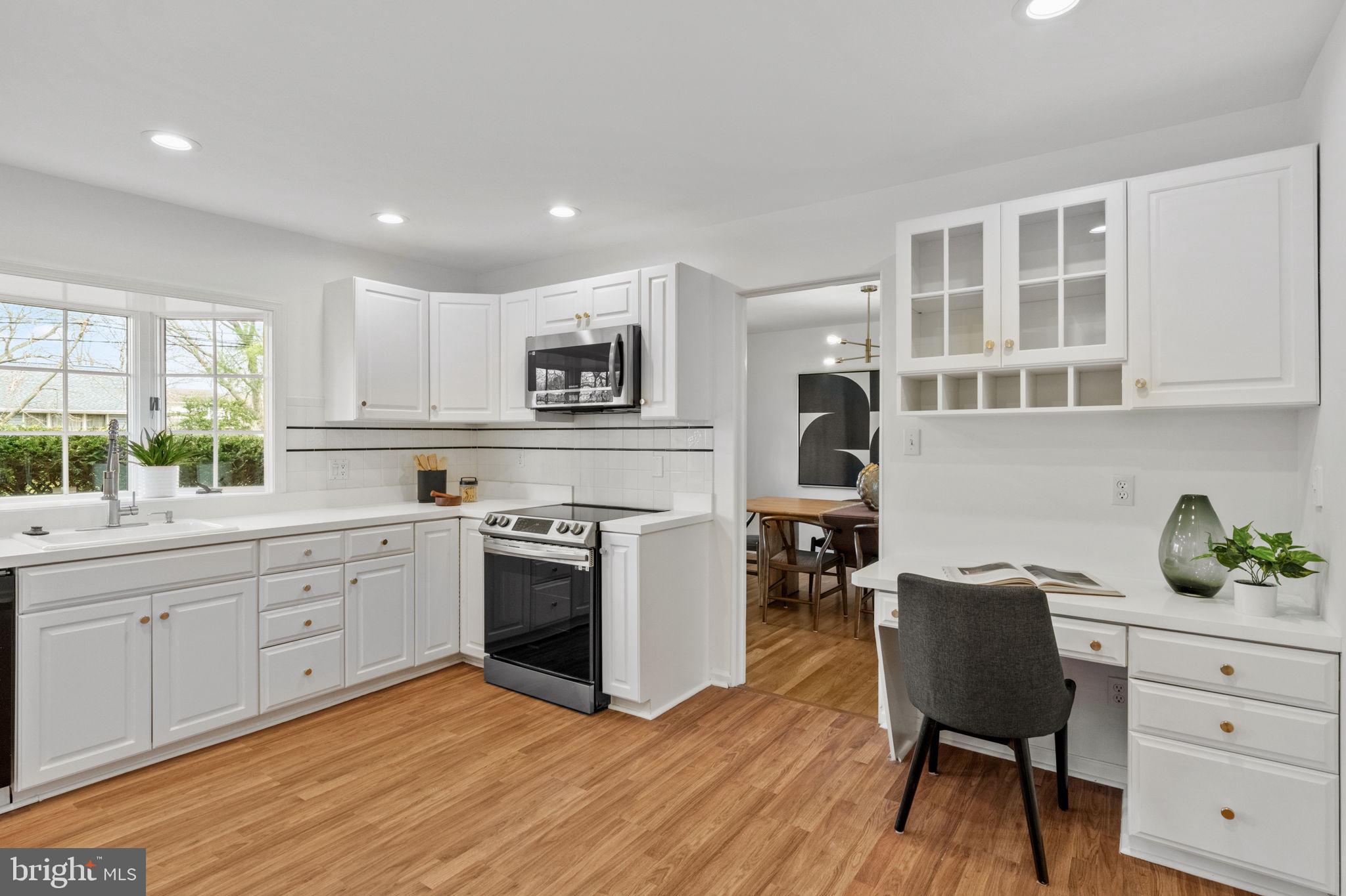 2529 Raven Road Wilmington, DE 19810 - Photo 3 of 80 a kitchen with a stove a sink a dining table and chairs