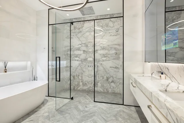 a bathroom with a tub sink and mirror