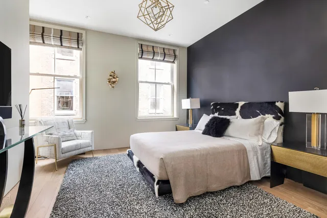 a bedroom with a bed a couch and a window