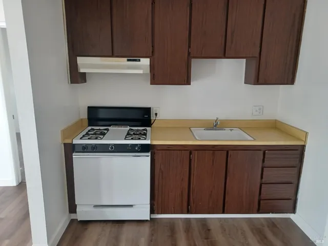 a kitchen with stainless steel appliances a stove and a microwave