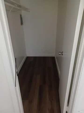 a bathroom with a granite countertop sink a toilet and shower