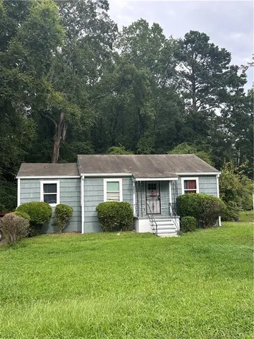 a front view of house with yard and green space