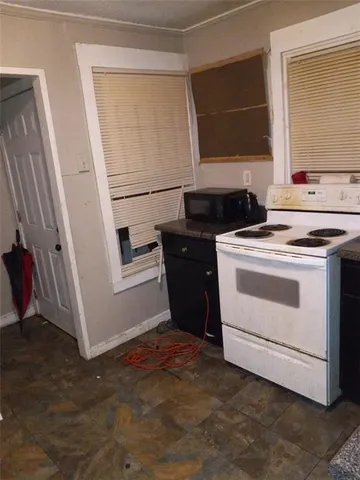 a kitchen with a stove microwave and sink