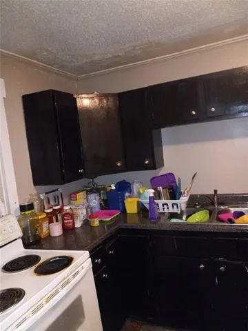 a kitchen with sink and cabinets