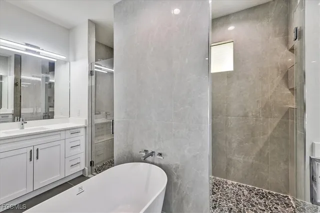 a bathroom with a bathtub and a sink