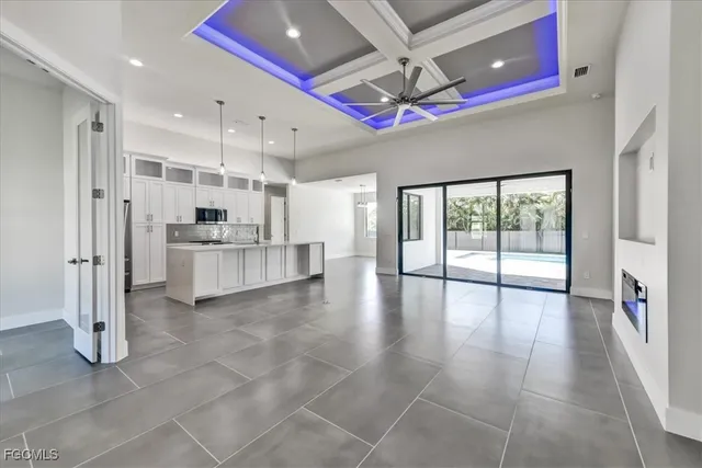 a large kitchen with stainless steel appliances granite countertop a refrigerator and a sink