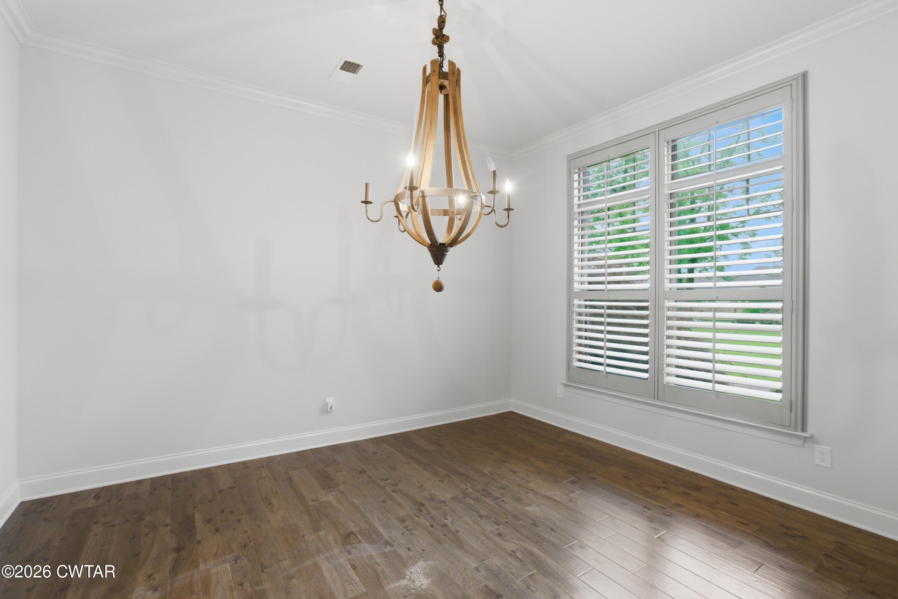963 Ashport Road Jackson, TN 38305 - Photo 20 of 60 a view of empty room with wooden floor and fan
