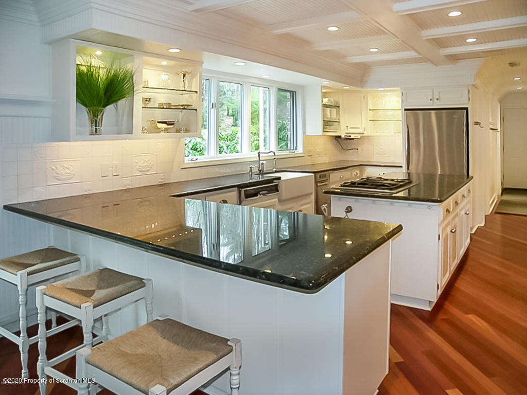 715 Lantern Hill Road Shavertown, PA 18708 - Photo 12 of 38 a kitchen with granite countertop a sink a counter top space and stainless steel appliances