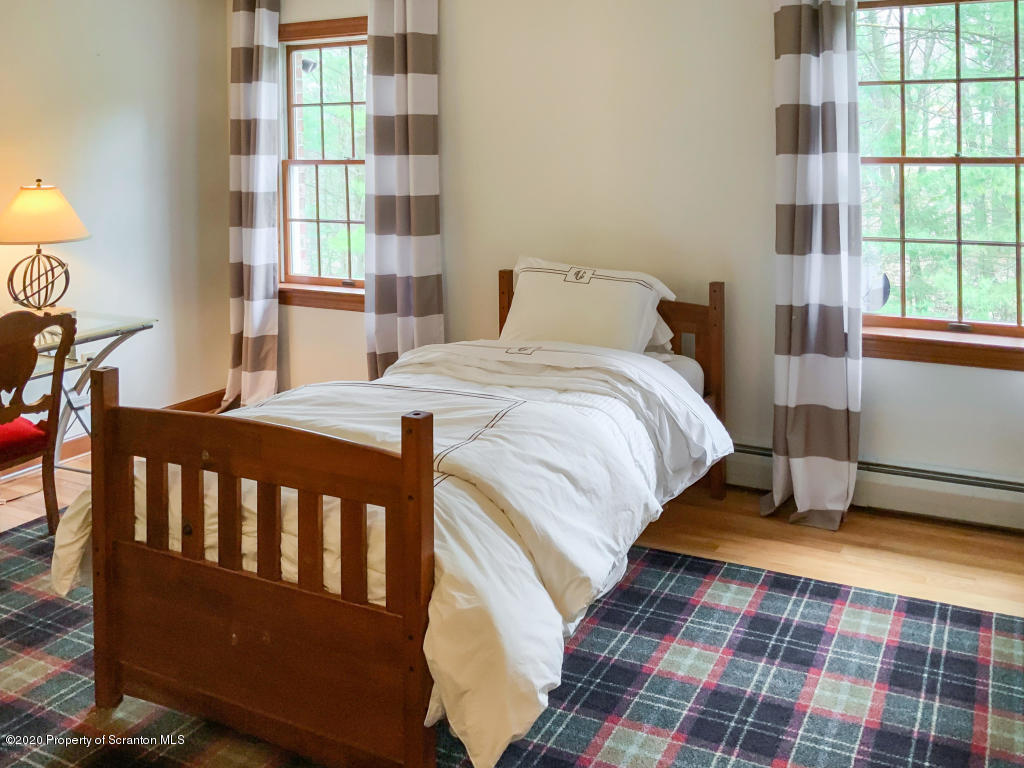 715 Lantern Hill Road Shavertown, PA 18708 - Photo 28 of 38 a bedroom with a bed and wooden floor