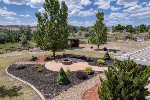 1407 North 1250th Street West Helper, UT 84526 - Photo 21 of 27 View of yard with an outdoor fire pit and an outdoor structure
