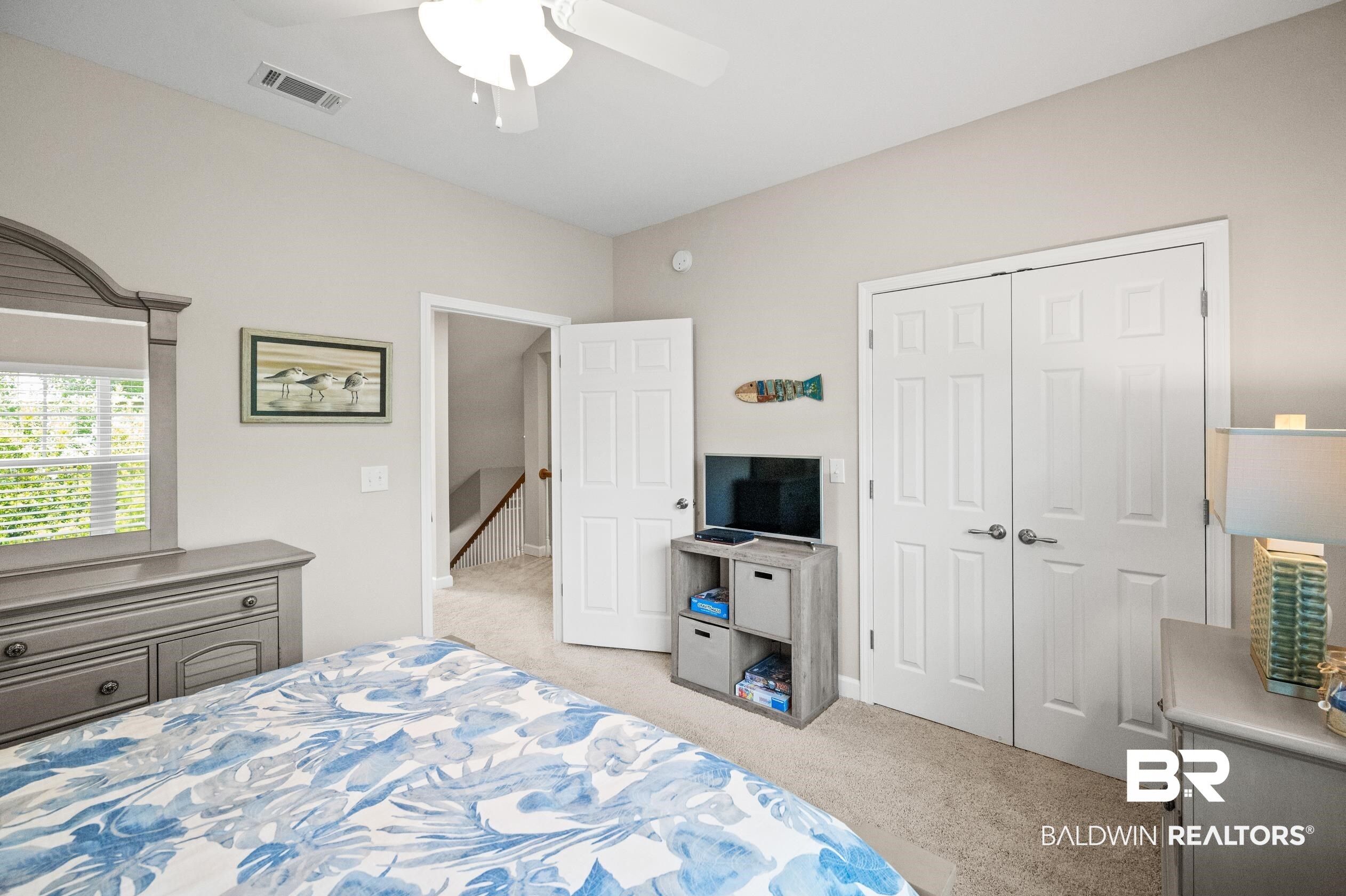 430 West Fort Morgan Road, Unit 1902 Gulf Shores, AL 36542 - Photo 30 of 59 Bedroom featuring light colored carpet, a closet, and ceiling fan