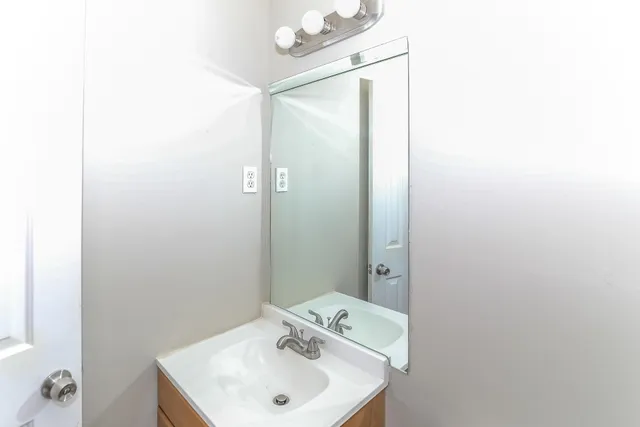 a bathroom with a sink and mirror