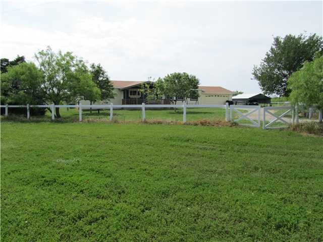 19715 Lockwood Road Manor, TX 78653 - Photo 1 of 1 a view of a golf course with a lake