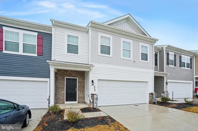 a front view of a house with a garage