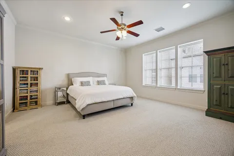 a spacious bedroom with a bed and a large window