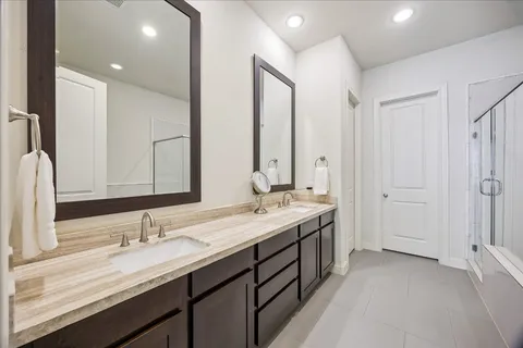 a bathroom with a double vanity sink and a mirror