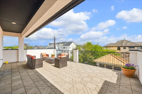 a view of roof deck with a barbeque and wooden stairs