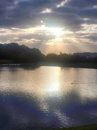 a view of a lake in middle of the middle of a yard