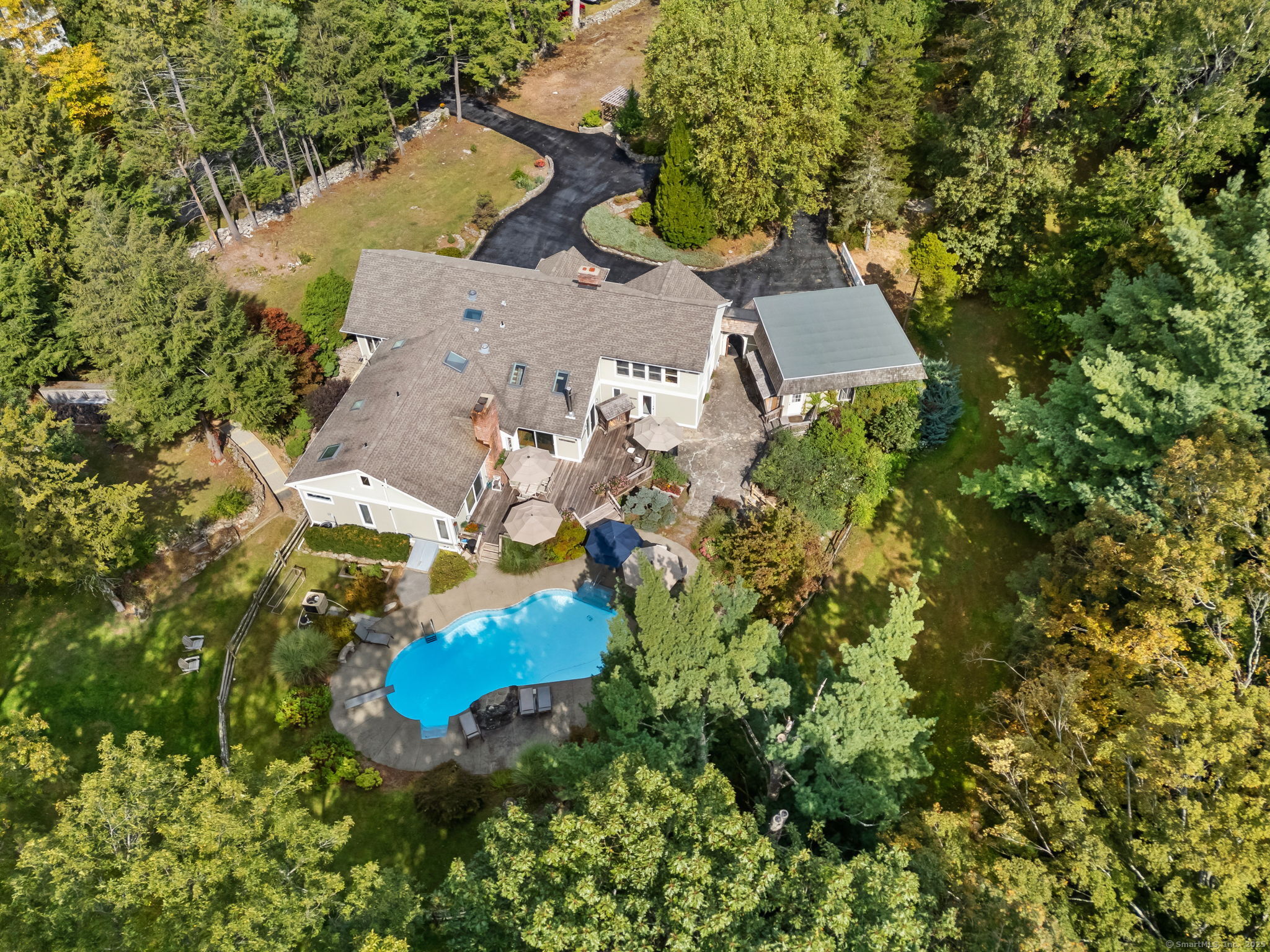 an aerial view of a house with a yard and swimming pool