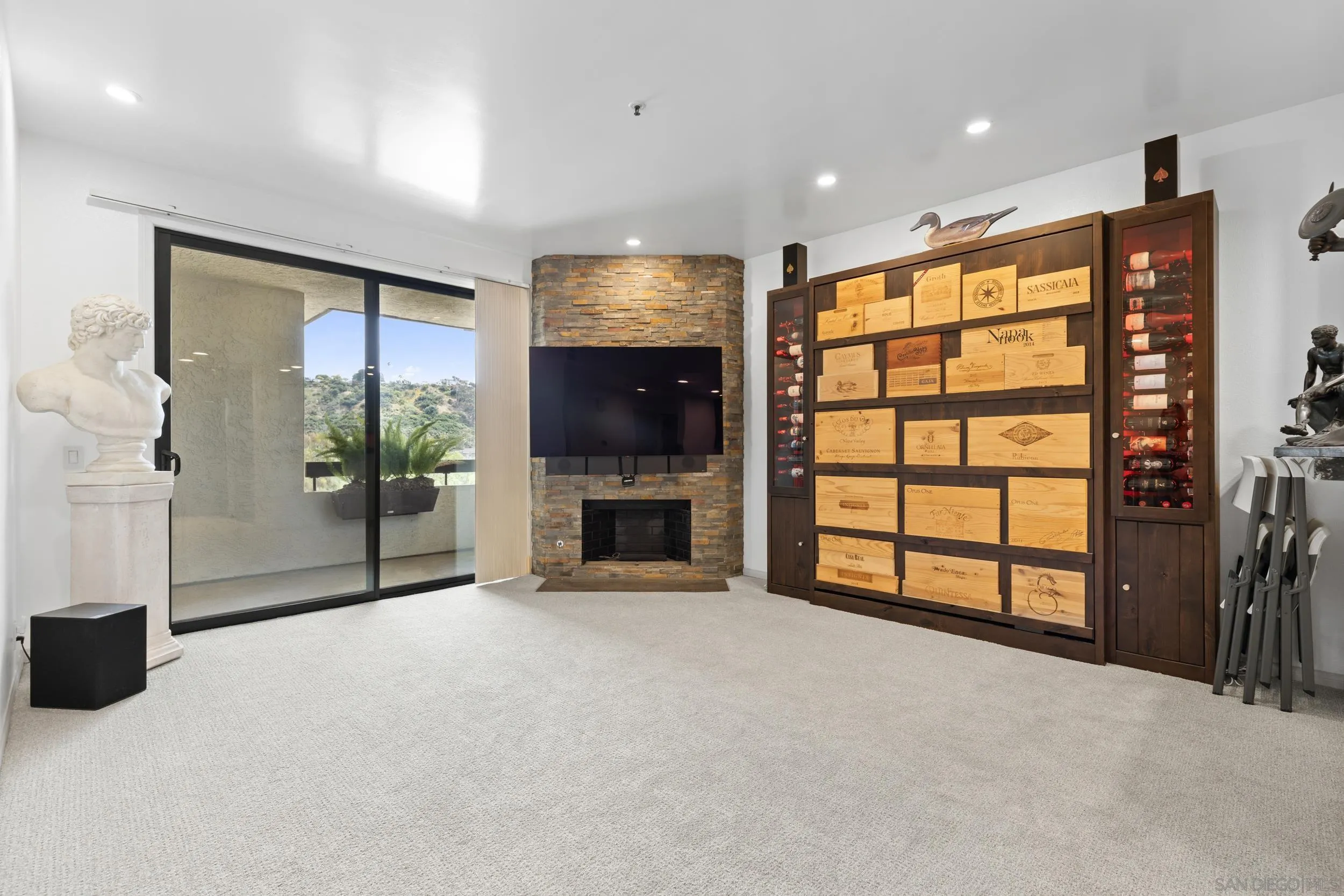5875 Friars Road, Unit 4410 San Diego, CA 92110 - Photo 3 of 25 a view of an empty room with a fireplace and a window