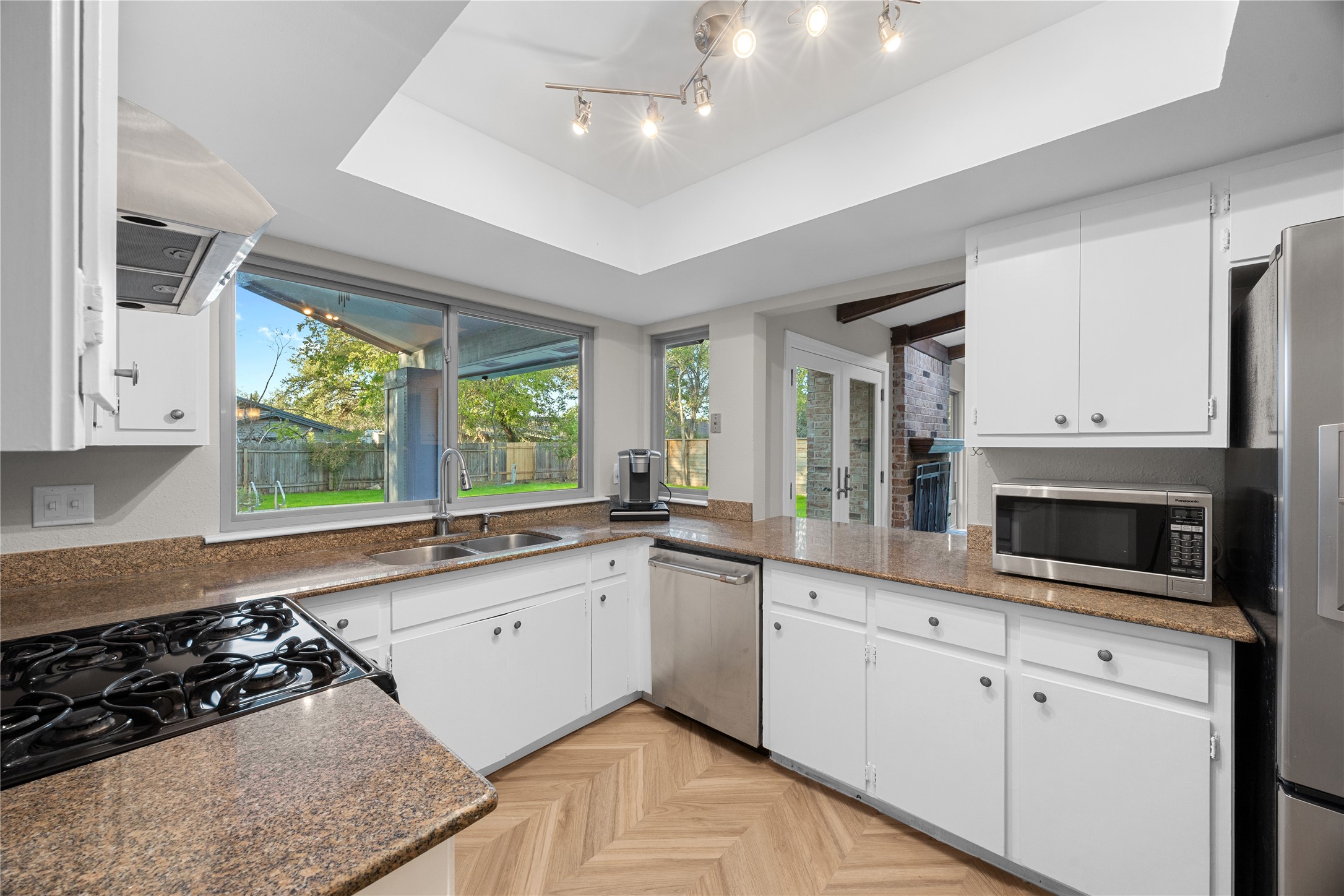 11714 Buckingham Road Austin, TX 78759 - Photo 11 of 34 a large kitchen with stainless steel appliances granite countertop a stove a sink and a white cabinets