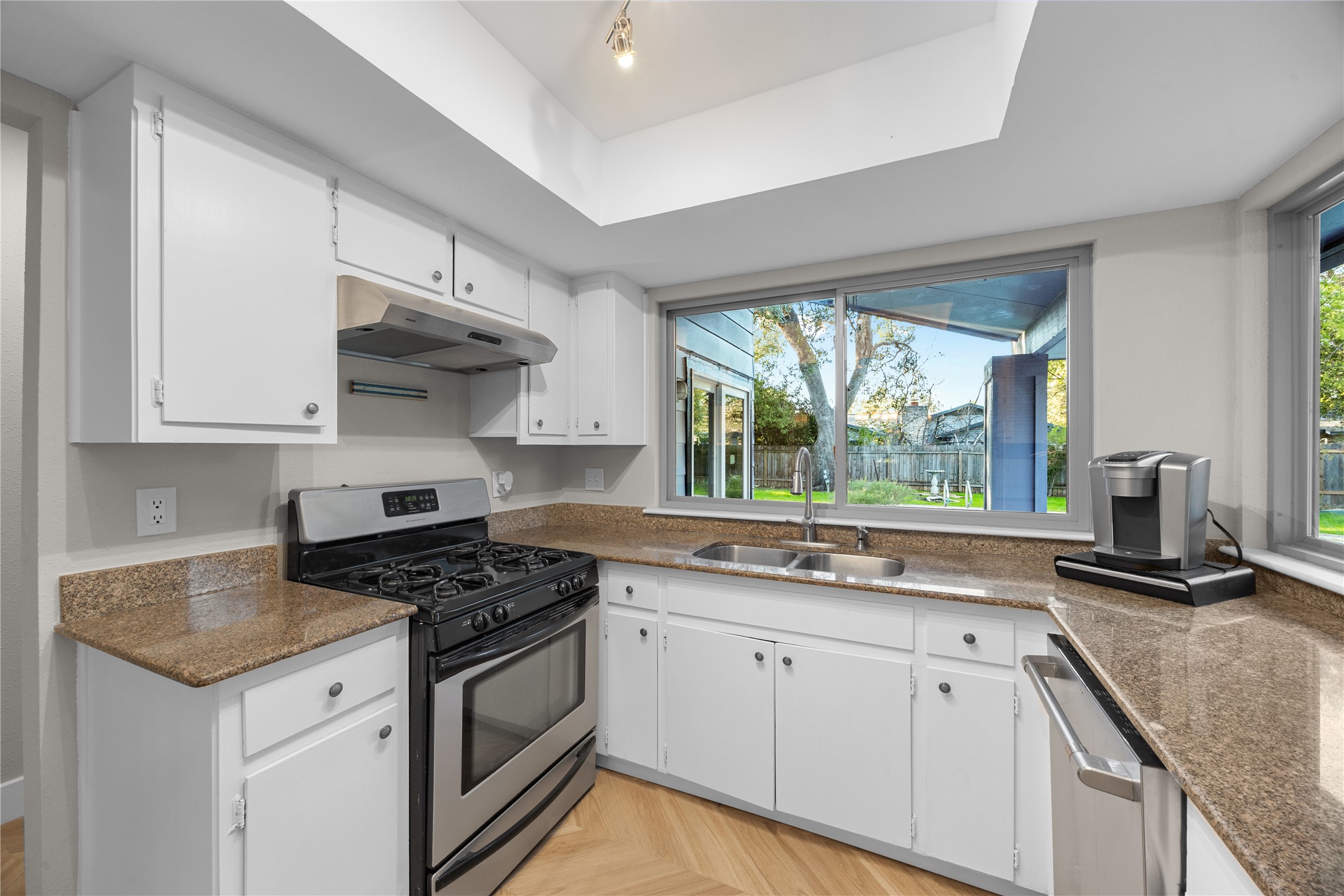11714 Buckingham Road Austin, TX 78759 - Photo 12 of 34 a kitchen with stainless steel appliances granite countertop white cabinets and a stove