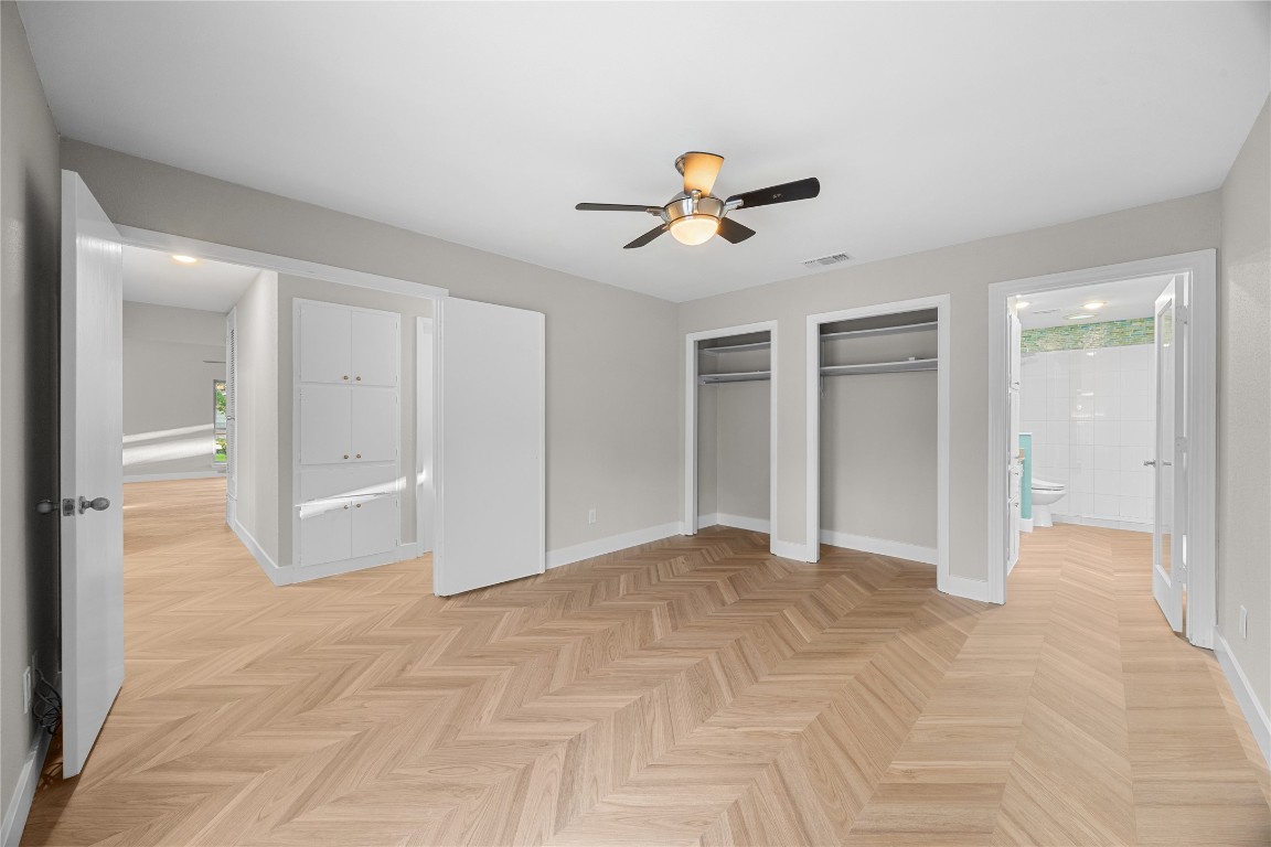 11714 Buckingham Road Austin, TX 78759 - Photo 19 of 35 Primary bedroom with ensuite bath and ceiling fan.