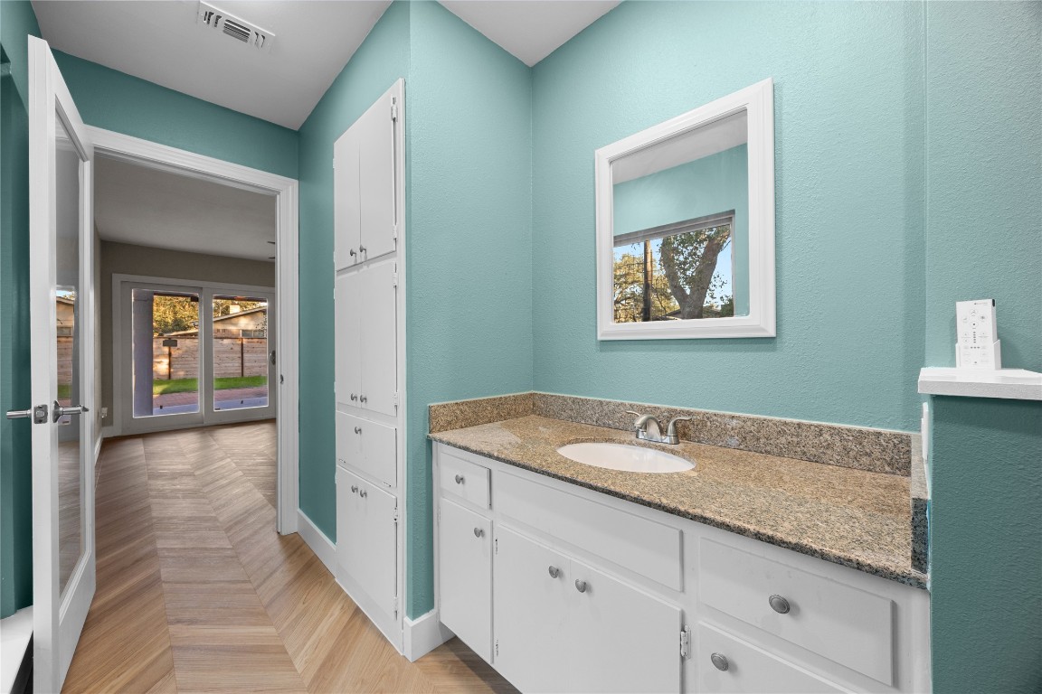 11714 Buckingham Road Austin, TX 78759 - Photo 21 of 35 Master bathroom featuring vanity, linen storage and baseboards.